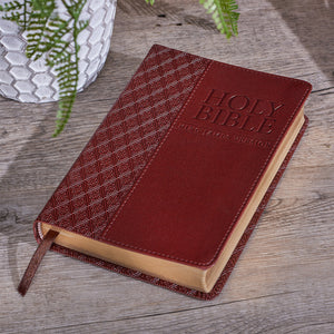 Bible laying on an outdoor table with plant