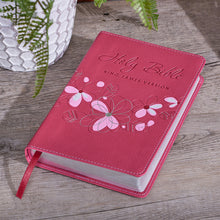 Bible laying on outdoor table with a plant