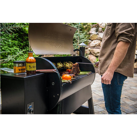 Pro Series 34 Pellet Grill TFB88PZB with man grilling food