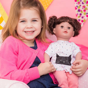 Little girl holding doll