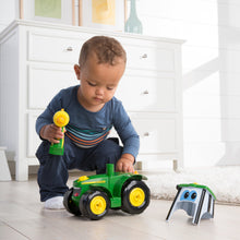 Child playing with tractor
