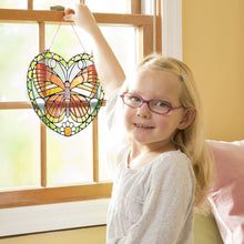 Girl holding up stained glasss butterfly