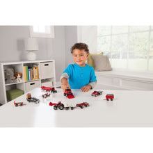 Child playing with tractor set