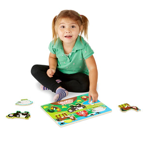 Girl playing with farm peg puzzle
