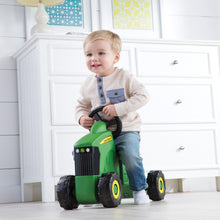 Boy riding toy tractor