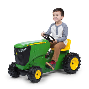Boy on pedal tractor