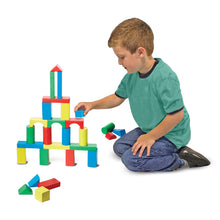 Boy playing with block set.