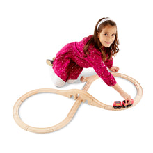 Girl playing with train set