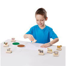 Boy playing with wooden stamps