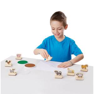 Boy playing with wooden stamps