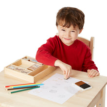 Boy playing with stamp set