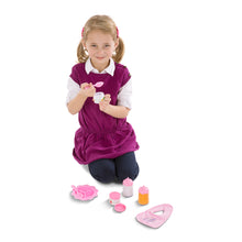 girl with doll feeding set