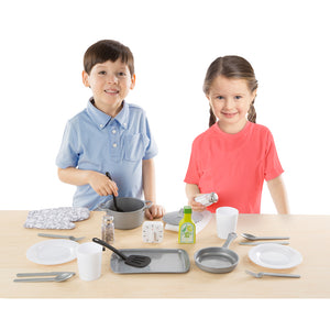 Boy and girl playing with kitchen set
