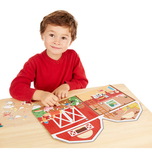 Boy playing with farm stickers