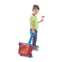 Boy pulling grocery basket