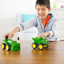 Boy playing with John Deere toys