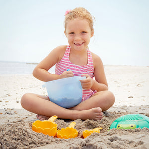 Girl using sand baking set