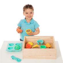 Boy playing with sand toys