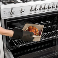 Silicone oven mitt removing something from the oven