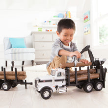 Boy playing with logging truck