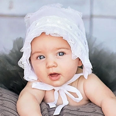 Little girl wearing White Ribbon Baby Bonnet